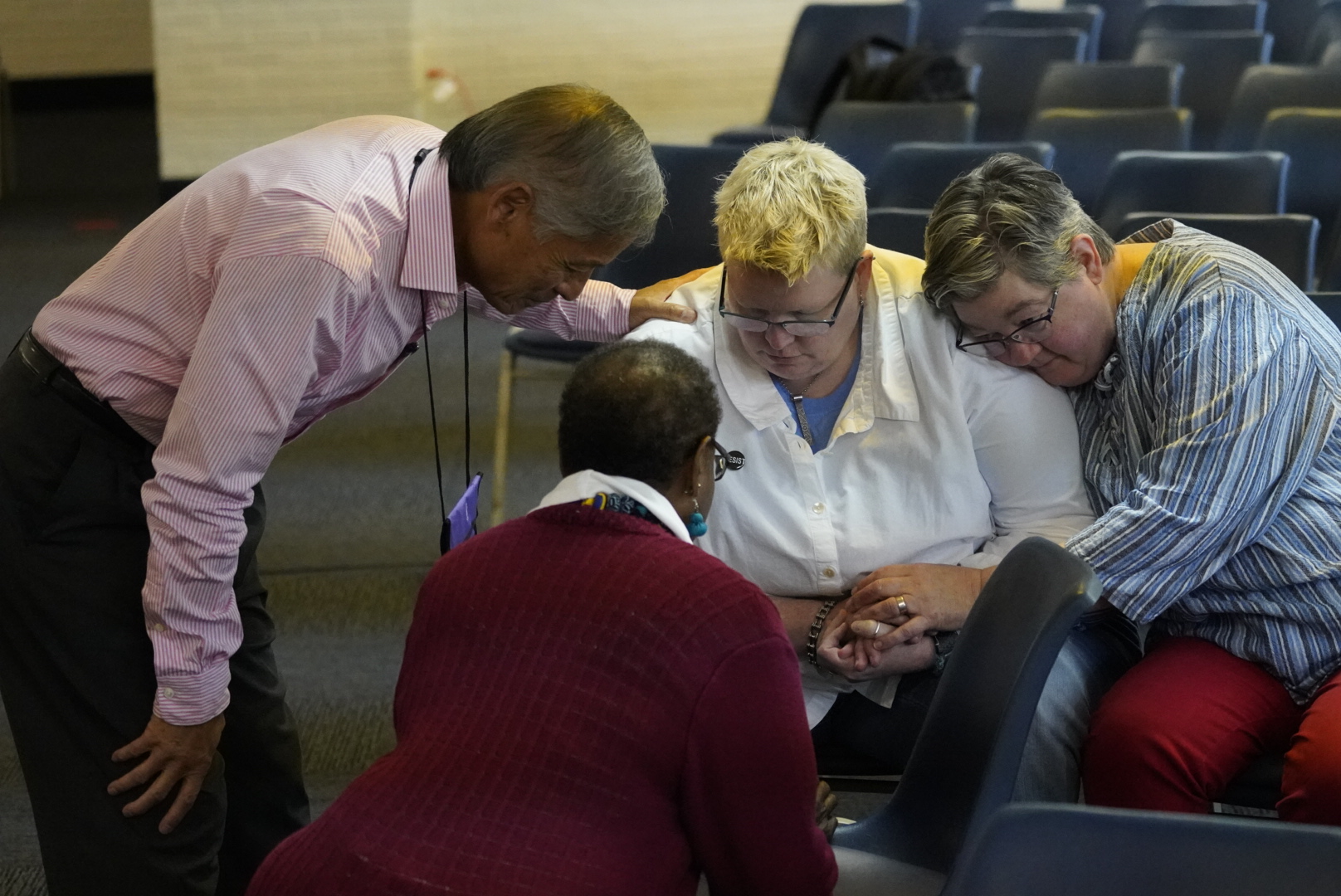 Bishops pray with representatives from the unofficial advocacy group Love Prevails during the Council of Bishops meeting in November. The group asked the bishops to address the LGBTQ community. Pictured from left are Bishops Grant Hagiya and Linda Lee praying with the Rev. Amy DeLong and her wife, Val Zellmer. Photo by Todd Rossnagel.