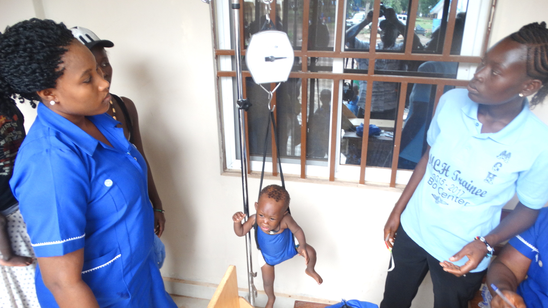 Staff at United Methodist Mercy Hospital in Bo, Sierra Leone, weigh a child during one of the hospital’s outreach days on the hospital grounds. Photo by Phileas Jusu, UMNS.