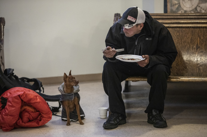 Mike Priest attends Sunday breakfast for the homeless at First United Methodist Church in Salt Lake City where pets are welcome. 
