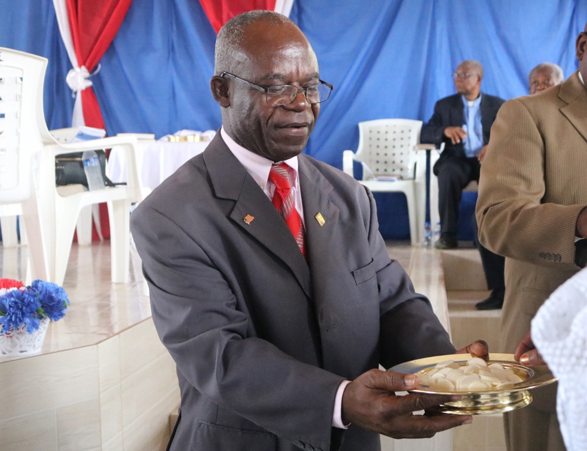 The Rev. Jerry P. Kulah serves communion during the opening session of the 72nd Annual Conference of  the United Methodist Women in Marshall, Liberia. Photo by E Julu Swen, UMNS.