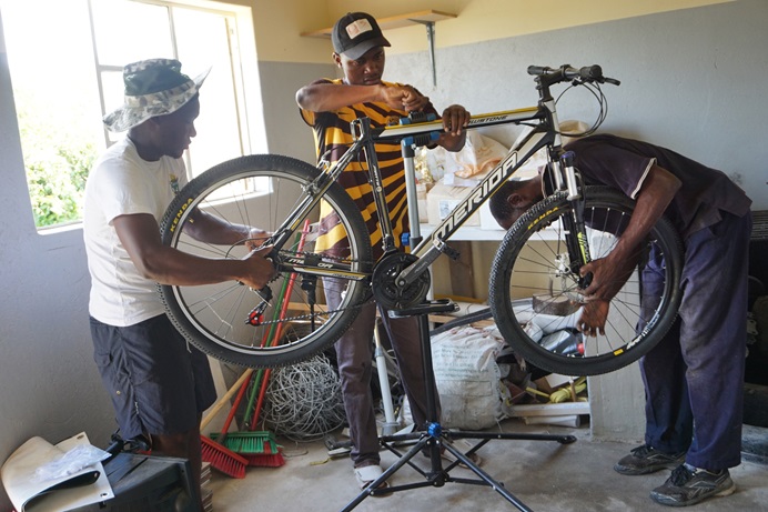 Gedion Mawoneke, Benjamin Dhliwayo and Damion Mutinhiri assemble a bicycle. United Methodist Church’s St. John’s Circuit in Mutare, Zimbabwe, is helping those in the Deaf community learn skills through the Holy Bike Sales project. Photo by Kudzai Chingwe.