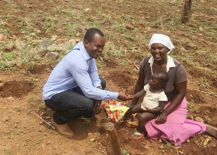 Cesar Lodiha Akoka, a theology student from Congo, helps a woman plant a seedling at Frickis Growth Point in Mutare, Zimbabwe. Akoka is one of several Africa University students working with local United Methodist congregations while studying abroad. Photo by Chenayi Kumuterera, UMNS.