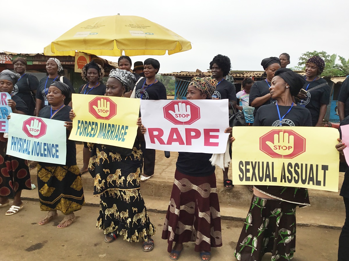United Methodist Women in Liberia display signs to protest against the rising wave of violence against women and girls in Liberia. The peaceful demonstration took place during the group’s 72nd annual session, held Jan. 21-27 in Marshall, Liberia. Photo by E Julu Swen, UMNS.