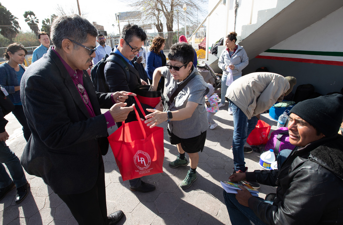 Bishop Felipe Ruiz Aguilar (left) of the Methodist Church of Mexico helps United Methodist Deaconess Cindy Johnson deliver food and sanitary supplies to migrants camped in Matamoros, Mexico, near the border with the U.S. Photo by Mike DuBose, UMNS.