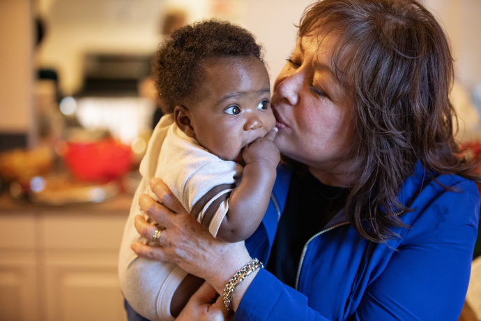 United Methodist Bishop Minerva Carcaño kisses 4-month-old Emanuel during a visit by the denomination's Immigration Task Force to La Posada Providencia, an emergency shelter for immigrants in San Benito, Texas. Emanuel's mother, an asylum seeker from Zimbabwe, gave birth while living in the shelter. Photo by Mike DuBose, UMNS.