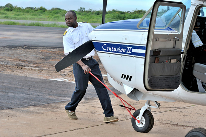 Rukang Chikomb, a pilot with the Wings of the Morning aviation ministry of The United Methodist Church, guides a plane into the program's hanger in Lubumbashi, Congo, in 2008.  File photo by Paul Jeffrey.