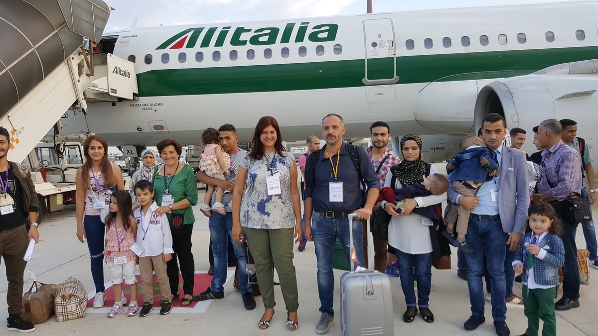 Asylum-seekers from Lebanon are greeted by Federica Brizi and Francesco Piobbichi of the Federation of Evangelical Churches in Italy (center) upon their arrival in Rome in August 2017. The group obtained legal visas through the Humanitarian Corridors program of the federation, the Synod of Waldensian and Methodist Churches and the Community of Sant’Egidio, run by Mediterranean Hope. Photo courtesy of Mediterranean Hope.