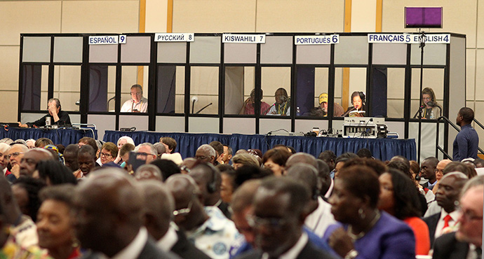 Language interpreters are vital to the work of General Conference. Here, working from booths behind seated delegates, they rendered in various languages a worship service at the 2016 General Conference in Portland, Oregon. Photo by Kathleen Barry, UMNS