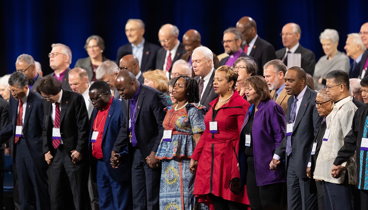 United Methodist bishops hold hands in prayer during a day of prayer for the 2019 United Methodist General Conference in St. Louis. Photo by Mike DuBose, UMNS.