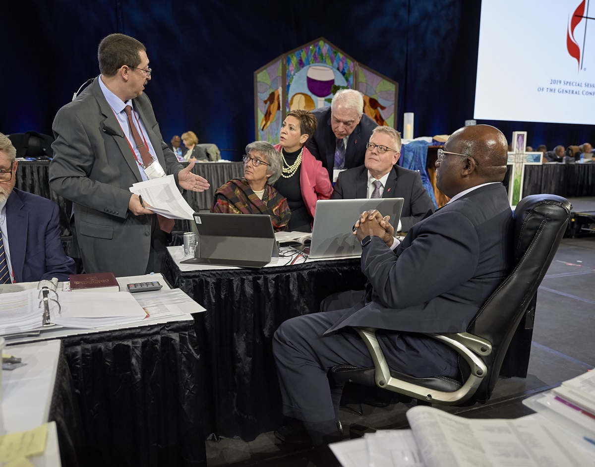 Following the announcement of a Judicial Council ruling that found several parts of the Traditional Plan unconstitutional, church officials confer during a pause in the Feb. 26 plenary session of the 2019 General Conference in St. Louis. Photo by Paul Jeffrey, UMNS.