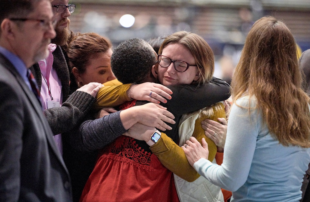 Delegate Shayla Jordan receives hugs after speaking in support of the One Church Plan during the 2019 United Methodist General Conference in St. Louis. Young United Methodists have differing views on whether the Traditional Plan, adopted by the special General Conference, is the best way forward for the denomination. Photo by Paul Jeffrey, UMNS.