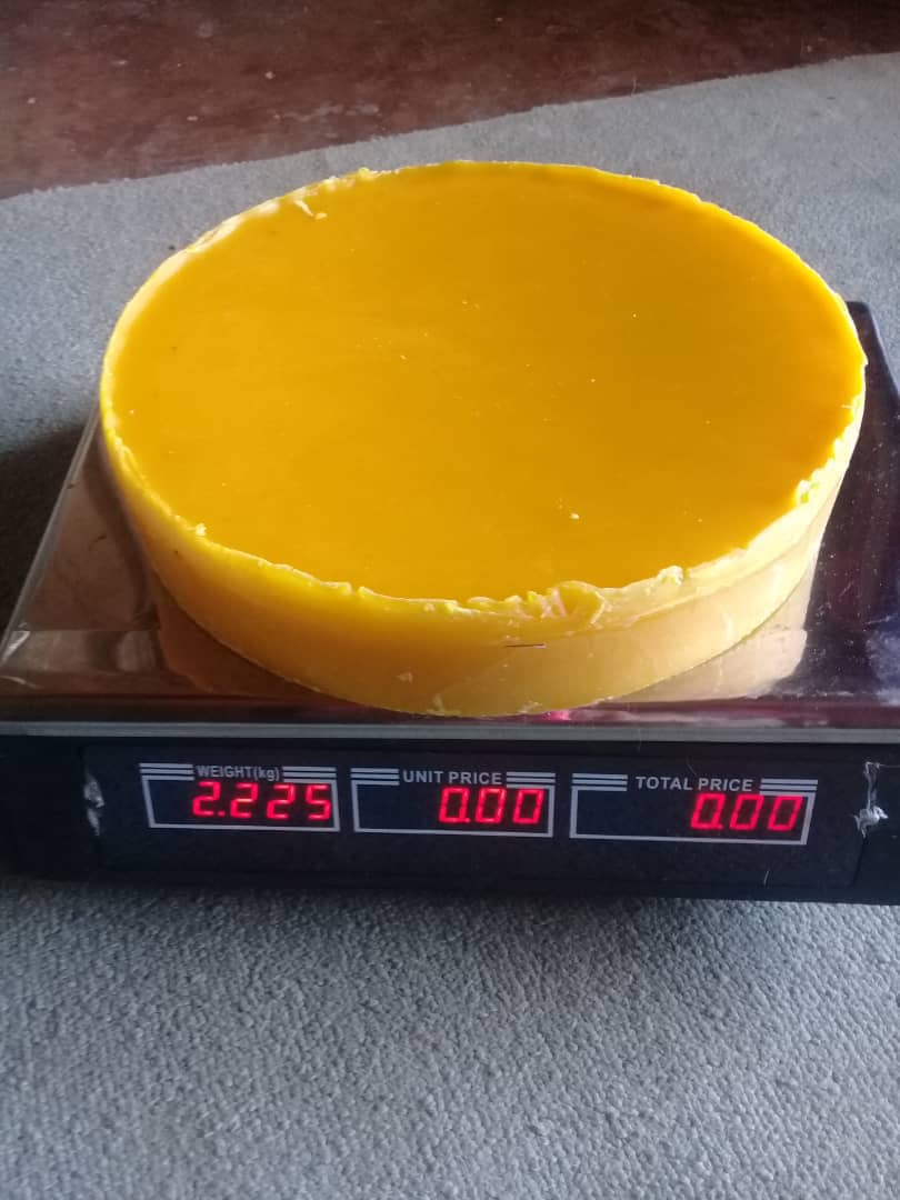 Beeswax is weighed before being sold at in Mutasa-Nyanga, Zimbabwe. Women in the Odzani Swarm Charm process honey, candles and shoe polish to sale at local markets. Photo by Kudzai Chingwe, UMNS.
