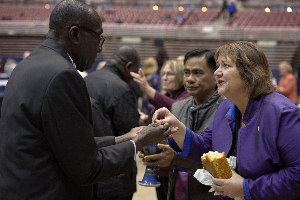 Bishop Karen Oliveto (right) shares bread with a delegate during a February 23, 2019, worship service in the special session of the General Conference of The United Methodist Church. Oliveto leads the Mountain Sky Area of The United Methodist Church.  Photo by Paul Jeffrey, UMNS.