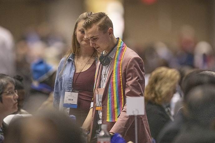 Young adult delegates gather in support of the words of Shayla Jordan who spoke against the Traditional Plan during day four of the United Methodist General Conference in St. Louis. In the foreground is Jeffrey "J.J." Warren of the Upper New York Conference. Photo by Kathleen Barry, UMNS.