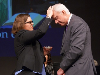 The Rev. Heather Sinclair anoints Bishop Thomas J. Bickerton at the beginning of a time of healing prayer and anointing at the close of a special session of the New York Annual Conference at Purchase College, State University of New York. Photo by Stephanie Parsons. The Rev. Heather Sinclair anoints Bishop Thomas J. Bickerton at the beginning of a time of healing prayer and anointing at the close of a special session of the New York Annual Conference at Purchase College, State University of New York. Photo by Stephanie Parsons.