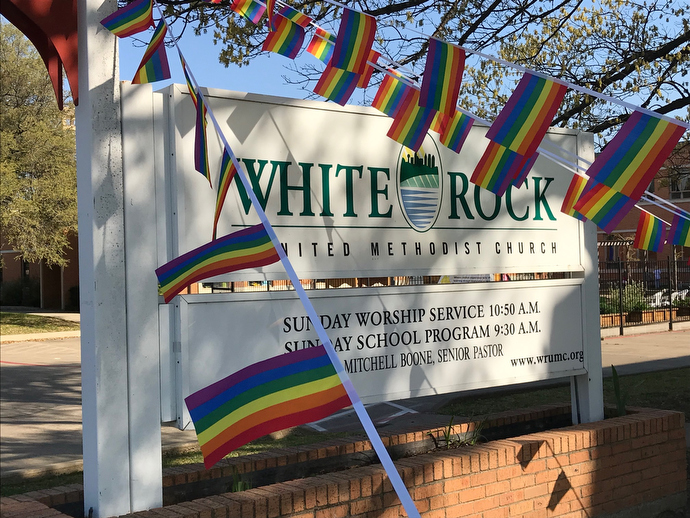 Rainbow flags fly from the sign at White Rock United Methodist Church in Dallas, just one indication of resistance to passage of the Traditional Plan at last month’s General Conference. The church’s pastor, the Rev. Mitchell Boone, has announced he’s willing to go against church law by performing same-sex weddings. Photo by Sam Hodges, UMNS.