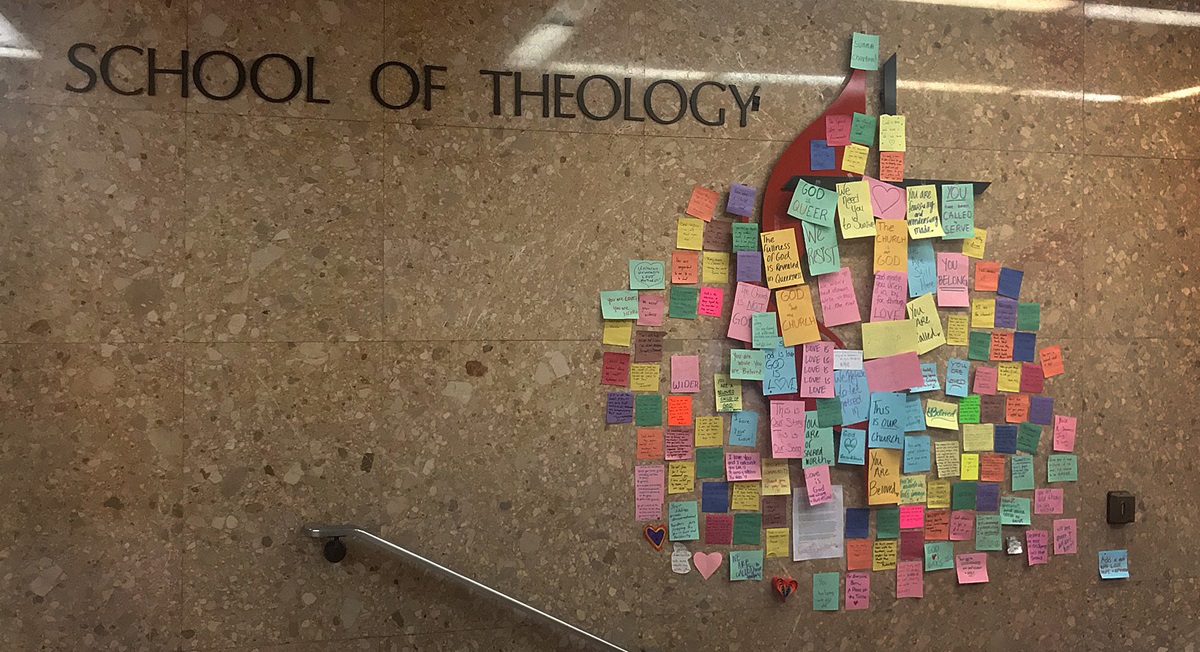 Messages of support for LGBTQ students cover the United Methodist cross and flame in a hallway at the Boston School of Theology after the special General Conference voted to affirm and strengthen the denomination’s rules against gay clergy and same-sex weddings. Photo by Anastasia Kidd, Boston School of Theology.