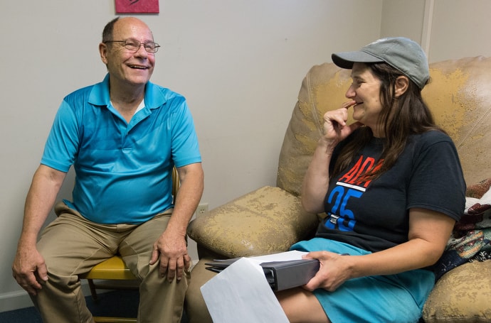 Paul Hanko (left) visits with client Beth Krause at Friendship House, a mental health drop-in center in Morgantown, W.Va. Hanko, a member of the men’s ministry at Spruce Street United Methodist Church, is part of a group from the church that visits regularly with clients at Friendship House and the associated needle exchange clinic. Photo by Mike DuBose, UMNS.