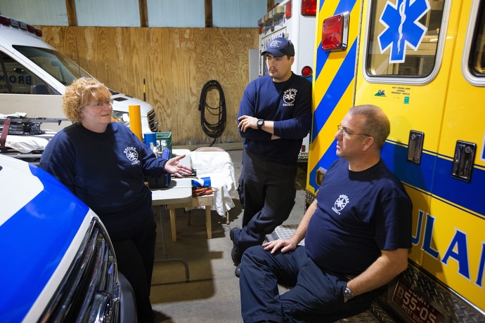 EMT Deb Dague (left) visits with EMT Ryan Seidewitz (center) and paramedic Jeff Luck at the Brooke County EMS station in Wellsburg, W.Va. Photo by Mike DuBose, UMNS.