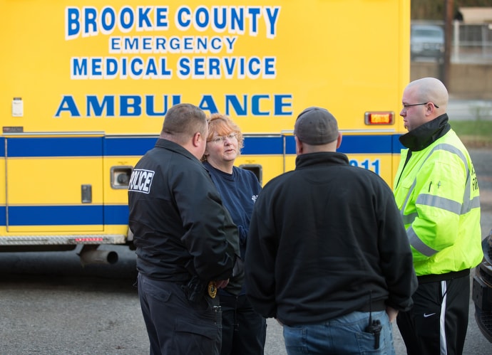 EMT Deb Dague (second from left) speaks with police and fire officials during a medical call in Wellsburg, W.Va. Photo by Mike DuBose, UMNS.
