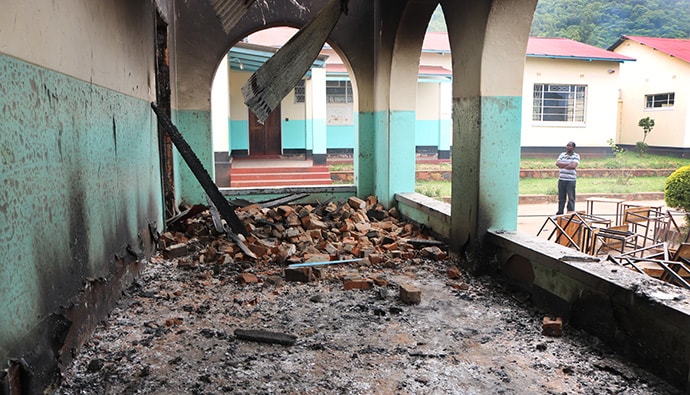 Debris blocks pathways around Hartzell High School, a United Methodist school at Old Mutare Mission in Mutare, Zimbabwe. Desks saved from the fire are piled outside the walls. Photo by Priscilla Muzerengwa, UMNS.