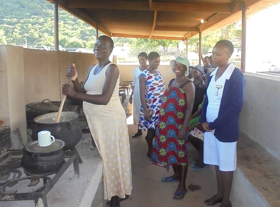 Mothers-to-be cook together in an open-air kitchen at the new mothers’ shelter in Mutare, Zimbabwe. The shelter for high-risk mothers was completed with a grant from the United Methodist Board of Global Ministries. Photo by Kudzai Chingwe, UMNS.
