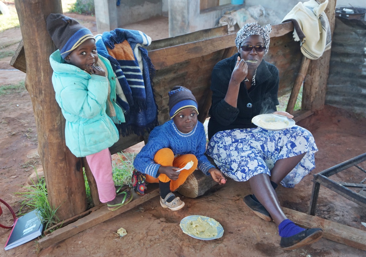 Irene Chingwaru eats with two of her surviving children at Ngangu United Methodist Church in Ngangu, Zimbabwe, after Cyclone Idai ravaged the region in March. She and her husband lost two sons, ages 9 and 14, in the cyclone. Photo by Kudzai Chingwe, UMNS. 