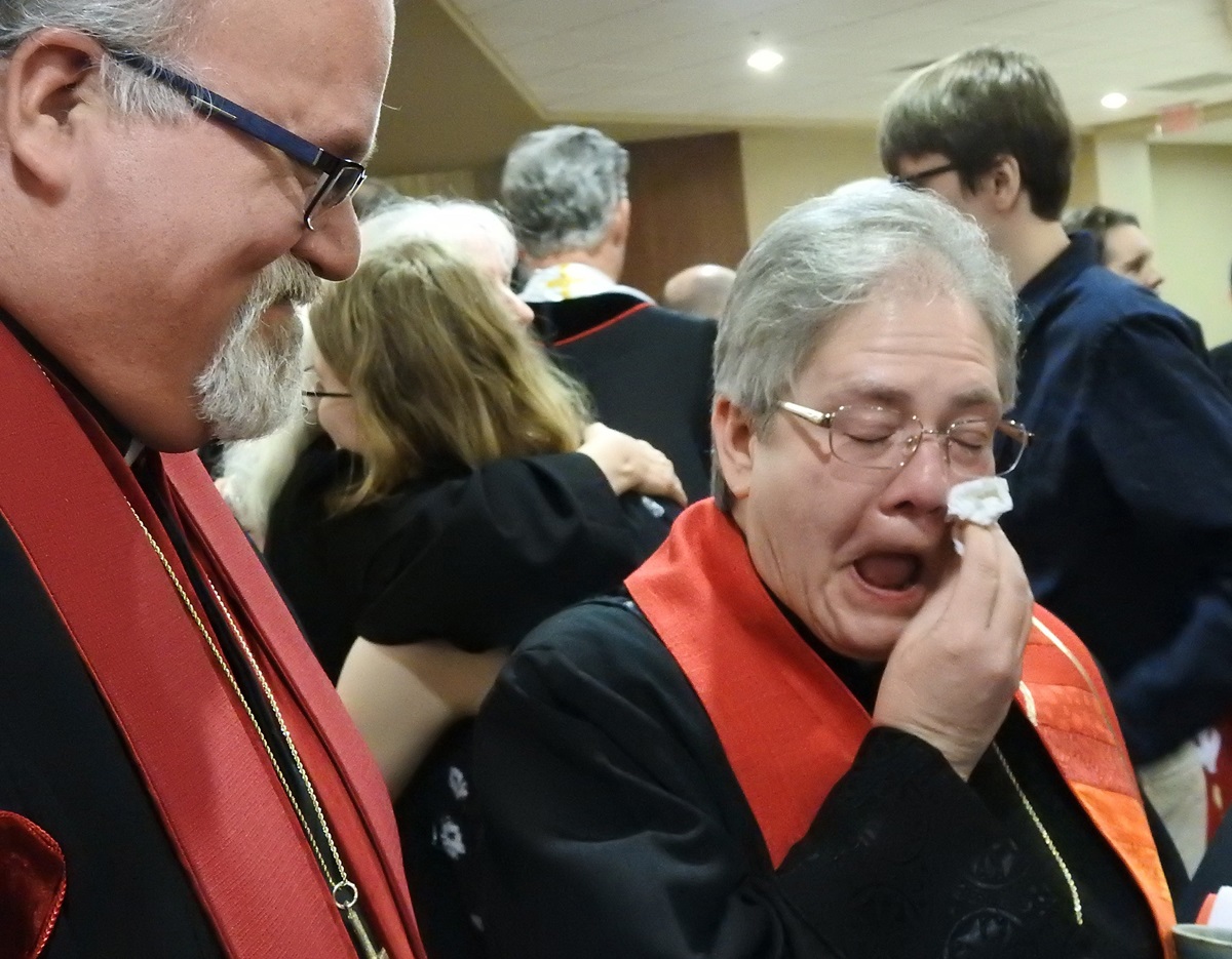 The Rev. Jane Graner wipes away tears after her June 3 ordination as an elder in the North Texas Conference. Graner, 57, is openly gay. Church law prohibits ordination of “self-avowed practicing” homosexuals, but conference officials noted her single status and said she qualified for ordination. Photo by Sam Hodges, UM News. 
