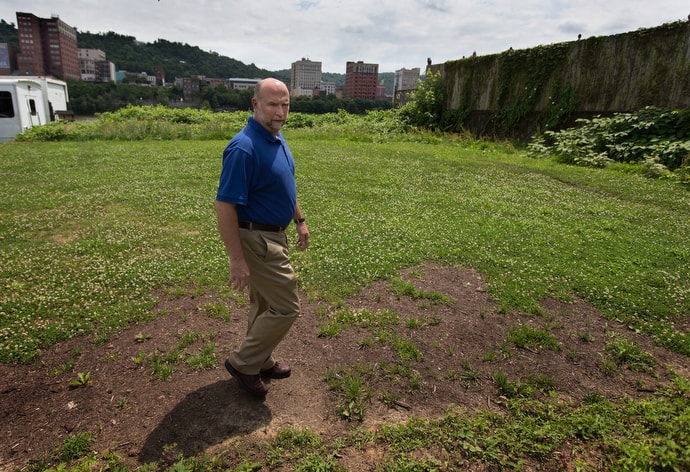 The Rev. Mike Linger describes plans to expand House of the Carpenter into a vacant lot next door to the present facility in Wheeling, W.Va. Photo by Mike DuBose, UM News.