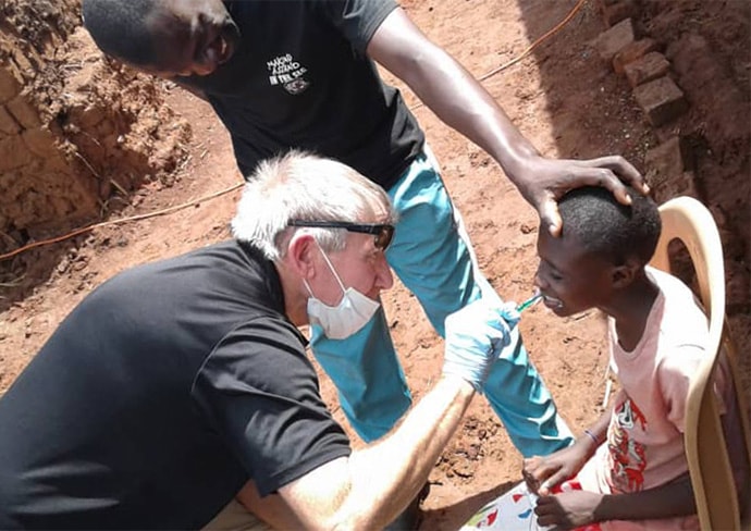 The Rev. Tom Wall, a United Methodist campus minister at the University of South Carolina, brushes a boy’s teeth during a free health camp in eastern Uganda. The United Methodist Church in Uganda and the African Methodist Episcopal Church jointly sponsored the weeklong event. Wall served as the team leader of the group from the United States. Photo by Vivian Agaba, UM News. 