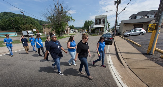 Kate Rhodes (right, foreground) leads students from House of the Carpenter back from a field trip on Wheeling Island. Photo by Mike DuBose, UM News.