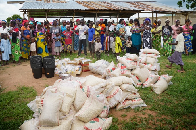 Residents at a camp for internally displaced persons in Jalingo, Nigeria, gather to receive food supplies provided by The United Methodist Church’s Nigeria Episcopal Area. The delivery for people displaced by violence occurred at a preaching center near the camp in Jalingo, Taraba State. Photo by Danny Mai, UMCom.