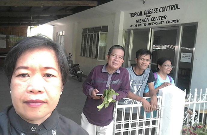 From left, the Rev. Glofie Baluntong, a United Methodist district superintendent, and the Revs. Wilfredo Yasay, Resty Herrera and Corazon Florece stand in front of the mission center at Dangay 3000 United Methodist Church in Roxas, Philippines. Photo courtesy of the Rev. Glofie Baluntong.