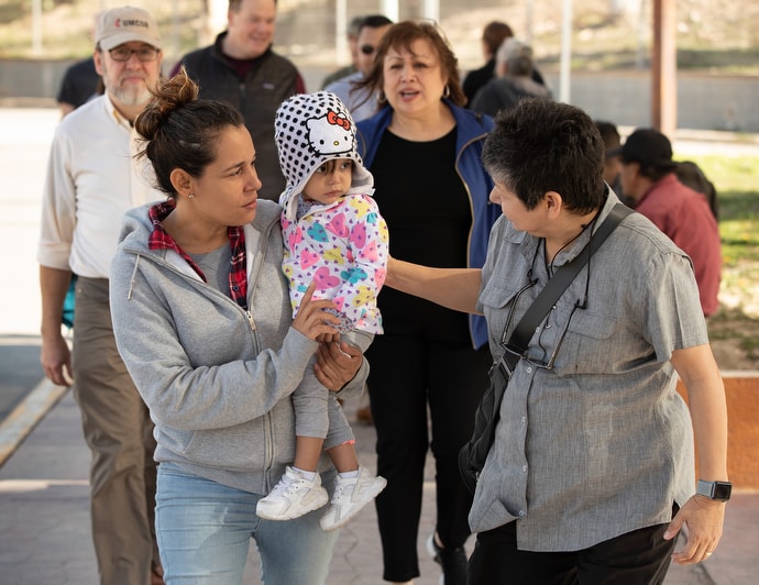 United Methodist deaconess Cindy Johnson (right) walks to buy medicine with Isabél, who traveled with her daughter from Nicaragua to Matamoros, Mexico, hoping to request asylum in the U.S. in January 2019. Kassandra, 16 months, was suffering from fever and weight loss while she and her mother waited for their turn to approach the bridge leading to Brownsville, Texas. Johnson makes regular visits to the border seeking to help migrant families. File photo by Mike DuBose, UM News.