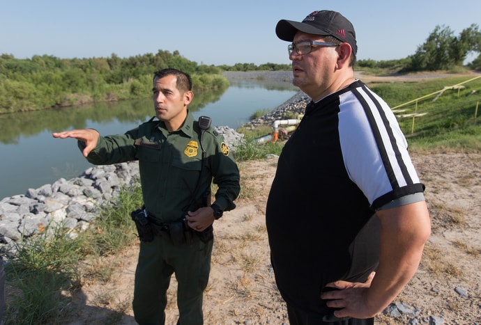 U.S. Border Patrol Agent Robert Rodriguez (left) shows the Rev. Robert Lopez an unfenced section of the U.S.-Mexico border along the banks of the Rio Grande near McAllen, Texas, in August 2018. Lopez is superintendent of The United Methodist Church's El Valle and Coastal Bend Districts in the Rio Texas Conference. File photo by Mike DuBose, UM News.