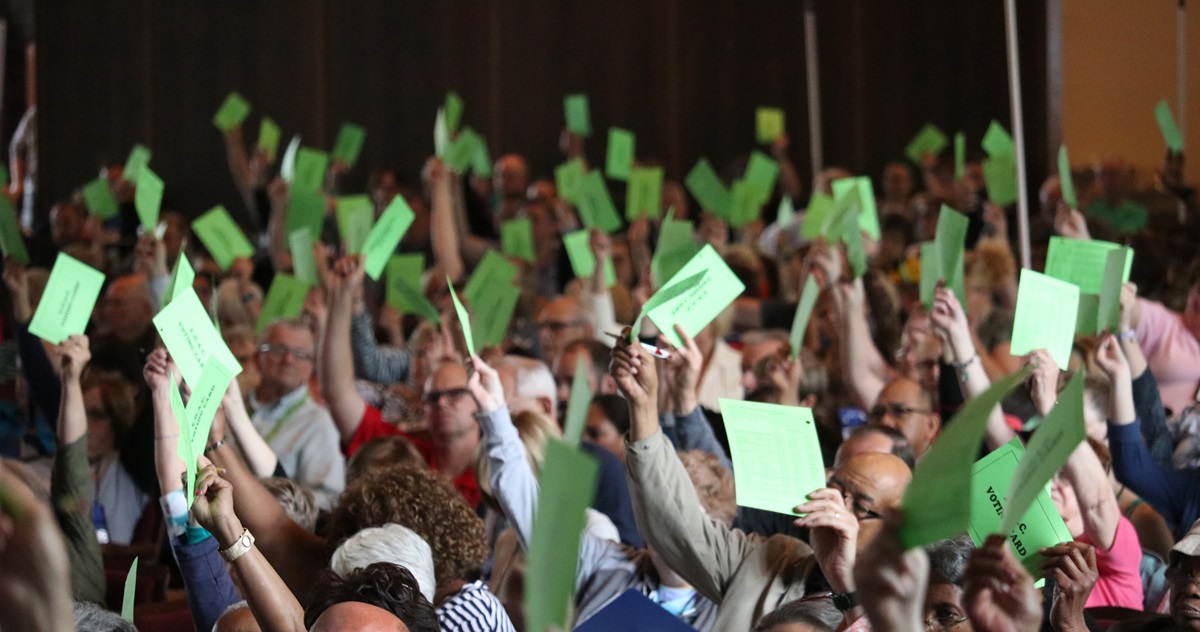 Clergy and lay members from the East Ohio Conference use their voting cards during the 2019 annual conference held at Lakeside Chautauqua. They use cards to cast votes for motions, resolutions and petitions but secret ballot for delegate elections. The conference elected a mix of delegates who support and oppose the Traditional Plan. Photo by Brett Hetherington, East Ohio Conference Communications.
