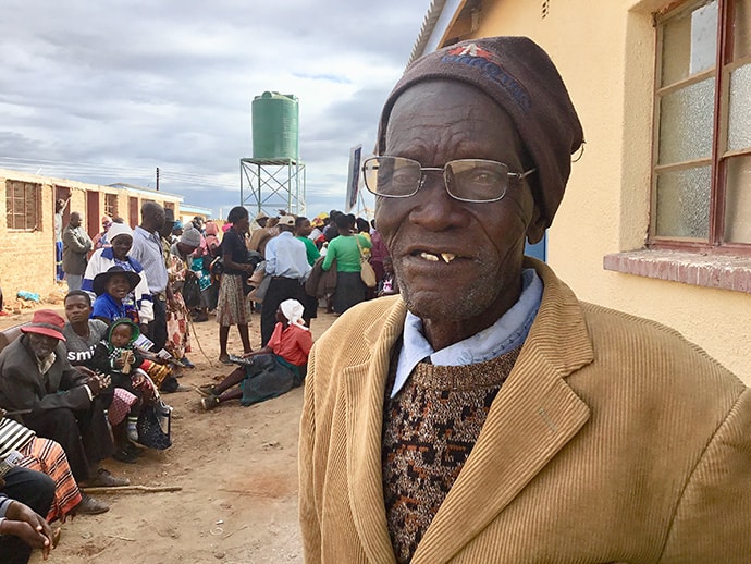 Kwedze Nyabani tries the new glasses he received during an outreach program at the Dindi United Methodist Clinic in Zimbabwe. Photo by the Rev. Taurai Emmanuel Maforo, UM News.