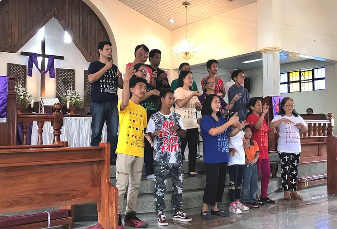 A United Methodist deaf choir signs the words of a hymn during worship in the Baguio Area in northern Philippines in April 2019. File photo courtesy of the Standing Committee on Central Conference Matters.
