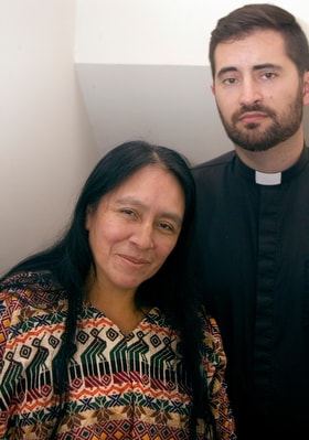 Maria Chavalan Sut stands with the Rev. Isaac Collins, pastor of Wesley Memorial United Methodist Church in Charlottesville, Va., during a news conference in October 2018. Chavalan Sut is living in the church to avoid deportation. Photo © Richard Lord.
