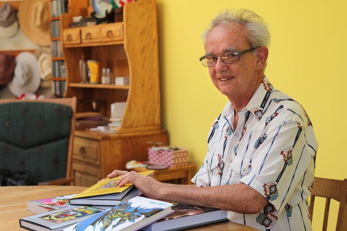 Mike Friedrich, shown at his home in Berkeley, Calif., shows off comic book stories he wrote as a young man. Today he is a United Methodist deacon in the Bay District of the California-Nevada Conference. Photo by Spud Hilton.