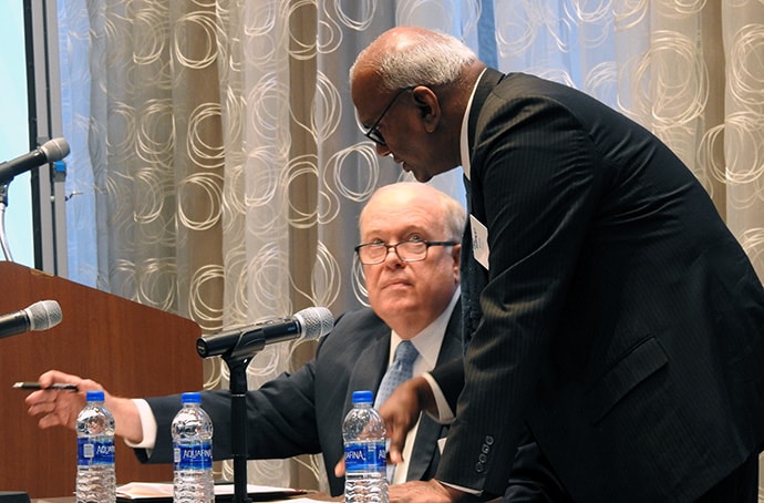 Bishop Michael McKee, president of the General Council on Finance and Administration, confers with Moses Kumar, GCFA’s top executive, on July 19 in Dallas. GCFA’s board heard that giving across the church is down since the 2019 General Conference in February. Photo by Sam Hodges, UM News.