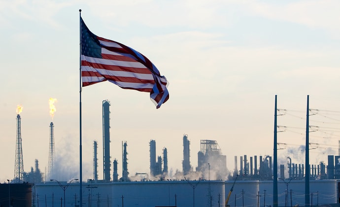 A U.S. flag flies above an oil refinery near Houston, Texas, in 2008. Wespath, the United Methodist pensions and benefits agency, is under pressure from environmental advocacy groups to divest from fossil fuel companies in response to concerns over climate change. File photo by Mike DuBose, UM News.