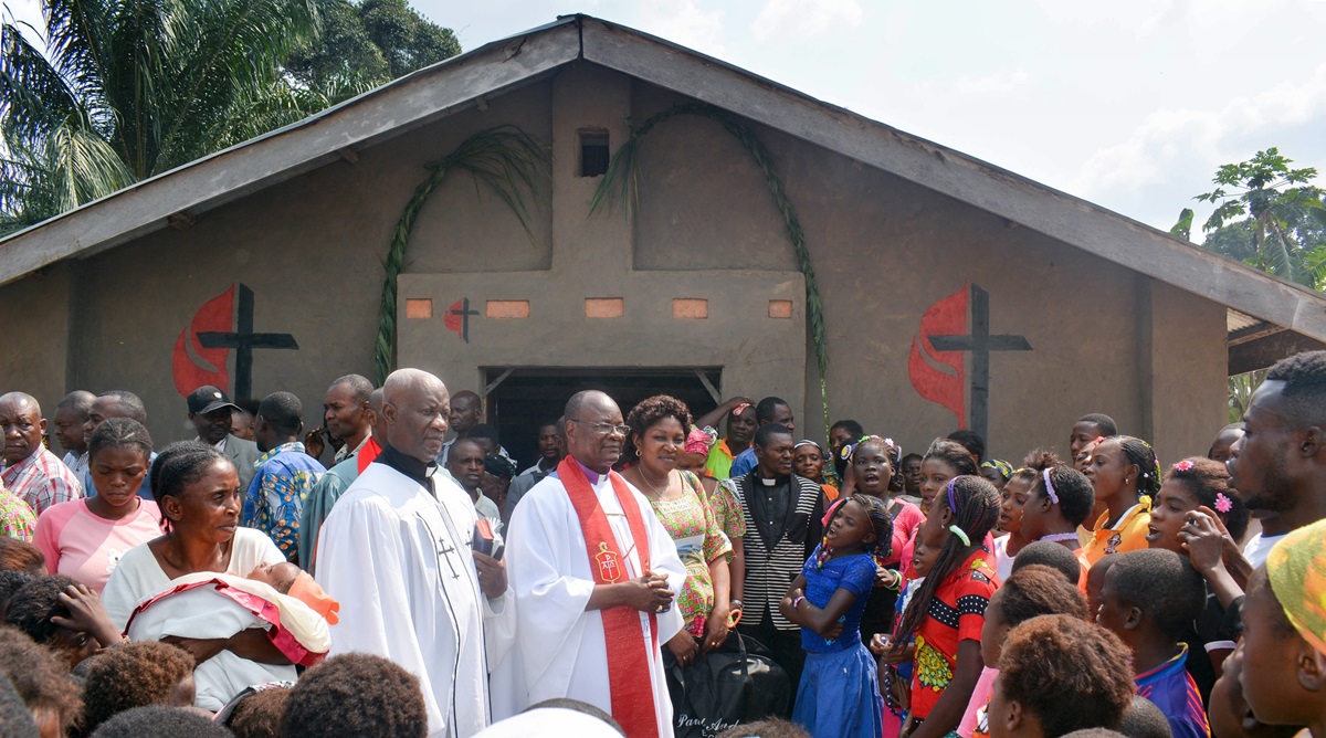 Bishop Gabriel Yemba Unda (center) helps rededicate the Yanda village United Methodist church, south of Kindu, Congo. Some 12 churches in the area have been renovated with more weatherproof materials with help from Martin (Tenn.) First United Methodist Church in the U.S. Photo by Chadrack Tambwe Londe, UM News.