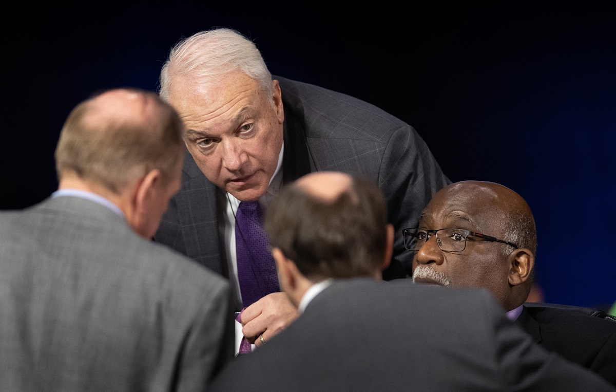 Bishops Thomas J. Bickerton (center) and Gregory V. Palmer (right) confer with colleagues on legislative procedures during the 2019 United Methodist General Conference in St. Louis. Bickerton is the Council of Bishops representative on the Commission on General Conference. The Commission on General Conference — meeting behind closed doors — reviewed an investigation that found evidence of four ineligible people casting votes using the credentials of delegates who were not present. File photo by Mike DuBose, UM News.