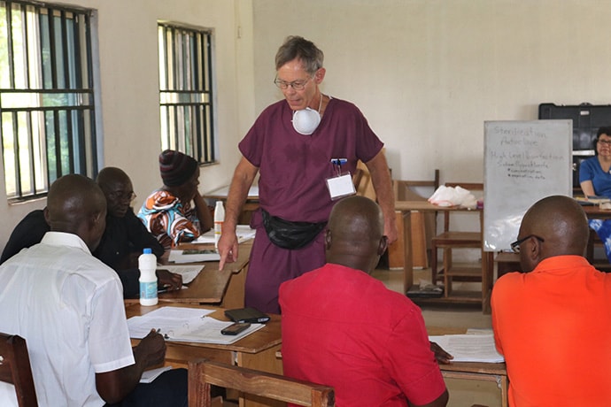 Dr. Bruce Cunningham (center) helps train community health workers to perform urgent-care dentistry during a workshop in Bambur, Nigeria. Cunningham is a board member for the Community Oral Health Initiative. Photo by Richard Fidelis, UM News.