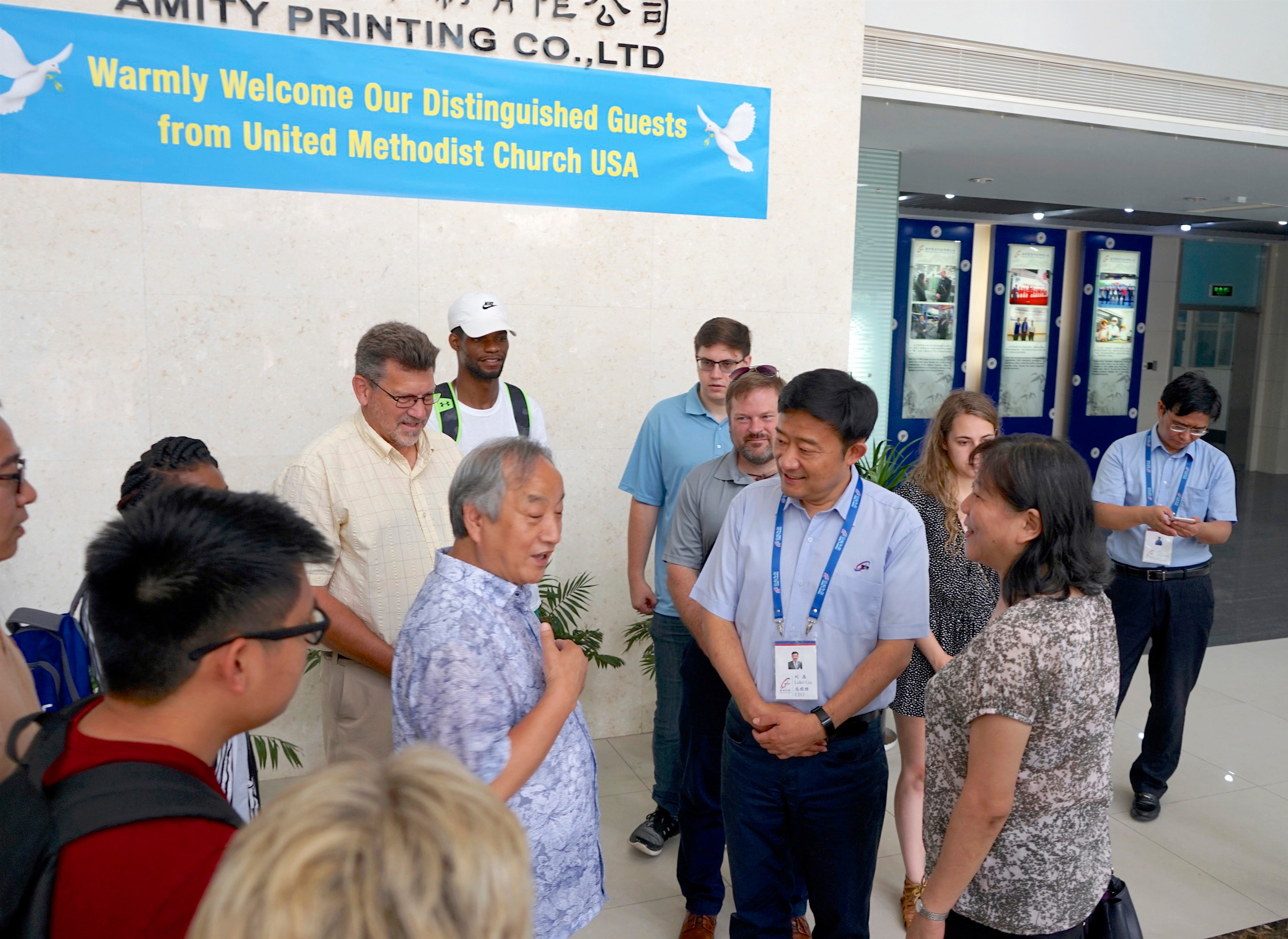 Wisconsin Area Bishop Hee-Soo Jung, center left, talks with officials from the Amity Printing Press in Nanjing, China, during a visit by a joint United Methodist Volunteers in Mission team from the denomination’s North Central and Northeastern Jurisdictions. In November, Amity will print its 200 millionth Bible and Jung is among the Christian leaders invited to come and mark the occasion. Photo courtesy of the Rev. David Newhouse.