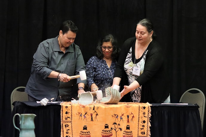 Members of MARCHA break a clay vessel as a symbol of the impact that decisions made by the 2019 General Conference have had on The United Methodist Church. From left are: the Revs. Vilma Cruz and Lucky Cotto and Pastor Imelda Roman. Photo by Michelle Maldonado, UMCOM.