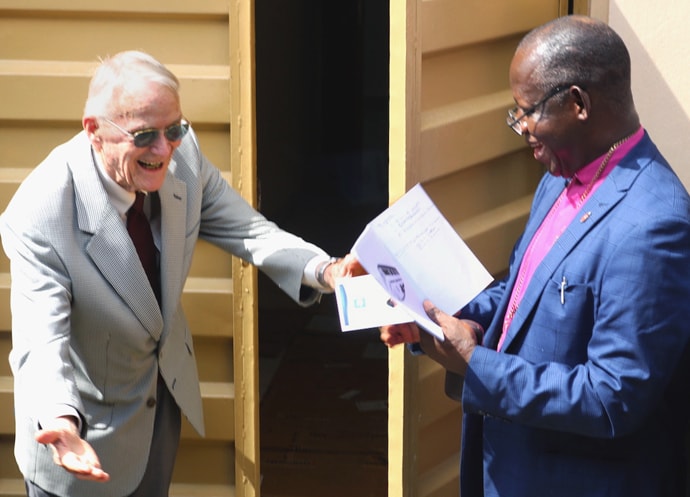 Dr. Lowell Gess (left) ushers Sierra Leone Area Bishop John Yambasu into the new surgical theater of the Lowell and Ruth Gess United Methodist Eye Hospital in Freetown, Sierra Leone, after a dedication ceremony in front of the building. Gess started the eye clinic at Kissy, rural Freetown at the time, creating a new level of eye care for West Africa. Photo by Phileas Jusu, UM News.