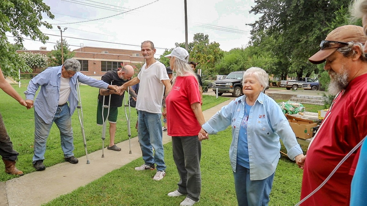 Alfreda Hibbard (second from right), age 81, leads a prayer for participants of the Billy Hooton United Methodist Church food bank in Oklahoma City, Okla. The outreach ministry has helped to feed Oklahoma City residents for nearly 30 years. Photo by Ginny Underwood, UM News. 
