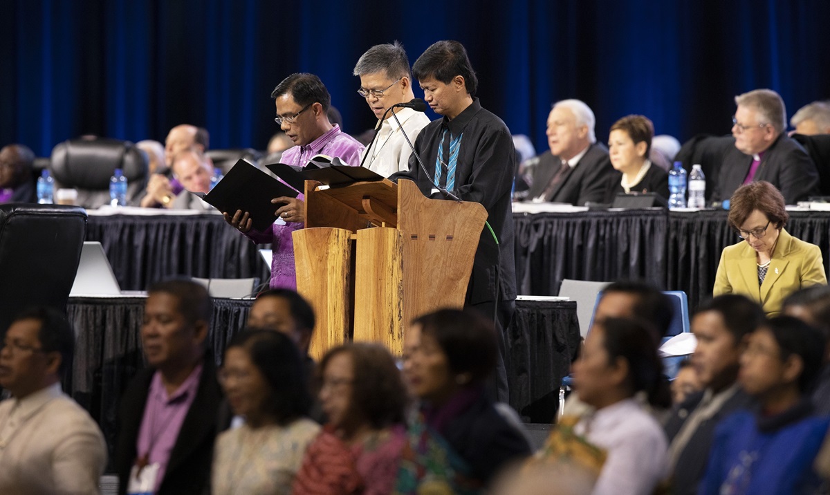 Bishops Rodolfo Alfonso “Rudy” Juan (left), Ciriaco Q. Francisco (center) and Pedro M. Torio Jr. lead a prayer for the Philippines and Southeast Asia during the 2019 United Methodist General Conference in St. Louis in February. The Philippines Central Conference College of Bishops, meeting in Manila, signed a resolution opposing dissolution of The United Methodist Church. File photo by Kathleen Barry, UM News.